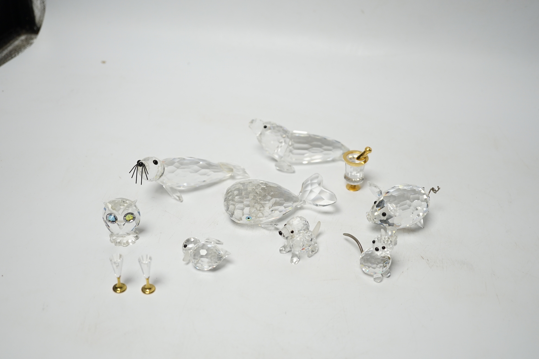Eight Swarovski crystal animal ornaments and a miniature set of a Champagne cooler and two Champagne glass flutes, (11)